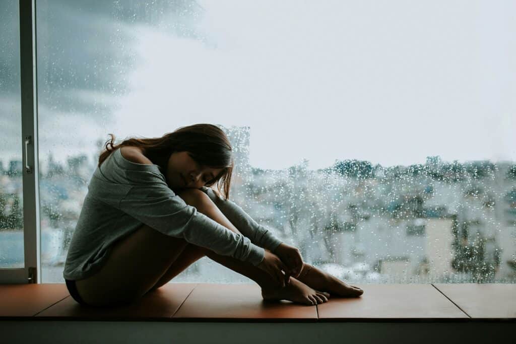 endometriose frau sitzt am fenster